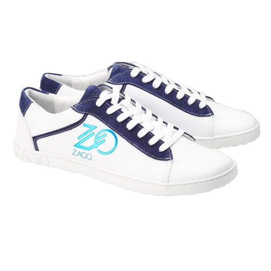 Ein Paar stylische ZAQQ CEDRIQ Blue-Sneaker in Weiß und Marineblau, verziert mit makellosen weißen Schnürsenkeln und einem auffälligen aquamarinfarbenen Logodesign an der Seite, vor einem schlichten weißen Hintergrund.